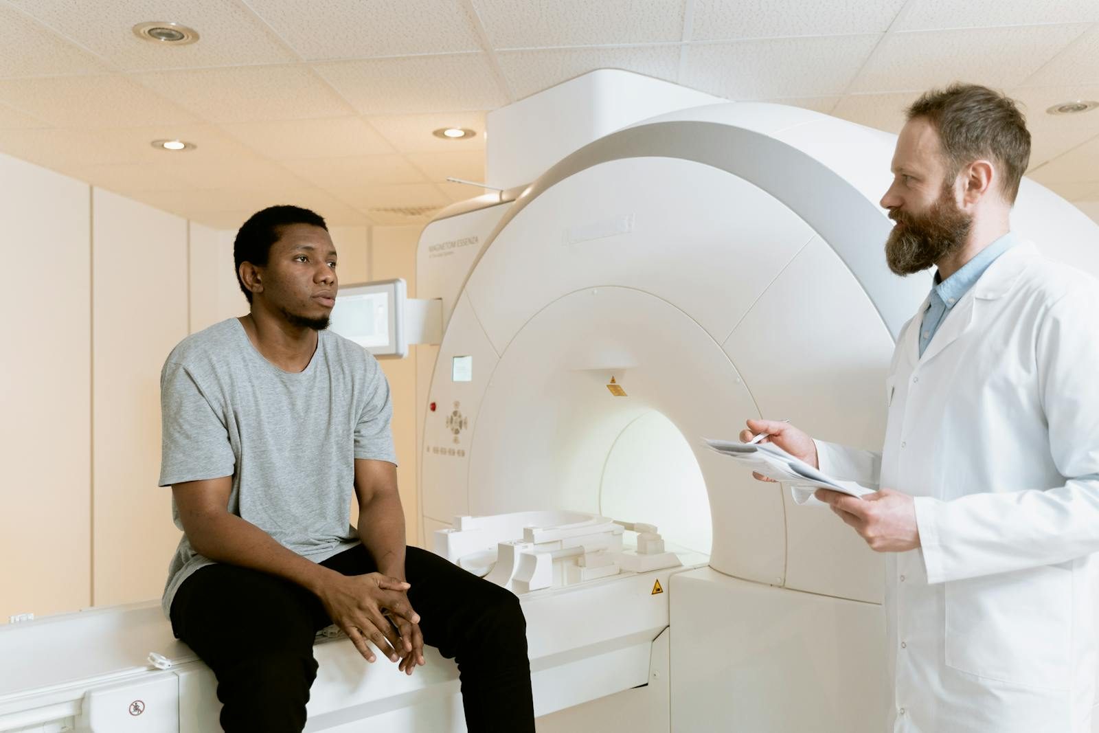 A doctor discusses MRI results with a patient in a hospital setting.