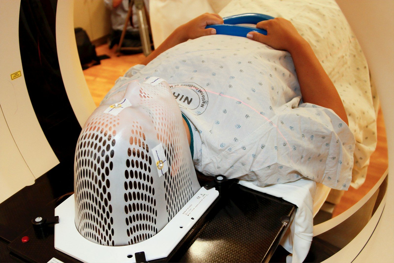 Patient undergoing radiation therapy with custom mask.